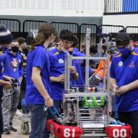 A team stands in the queue with their robot